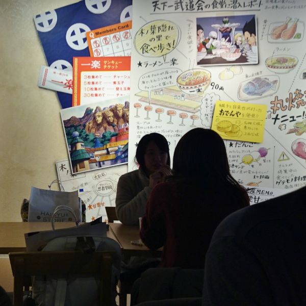 Guests enjoying anime-themed meals at J-World Kitchen, J-World Tokyo, featuring dishes inspired by Naruto, One Piece, and Dragon Ball