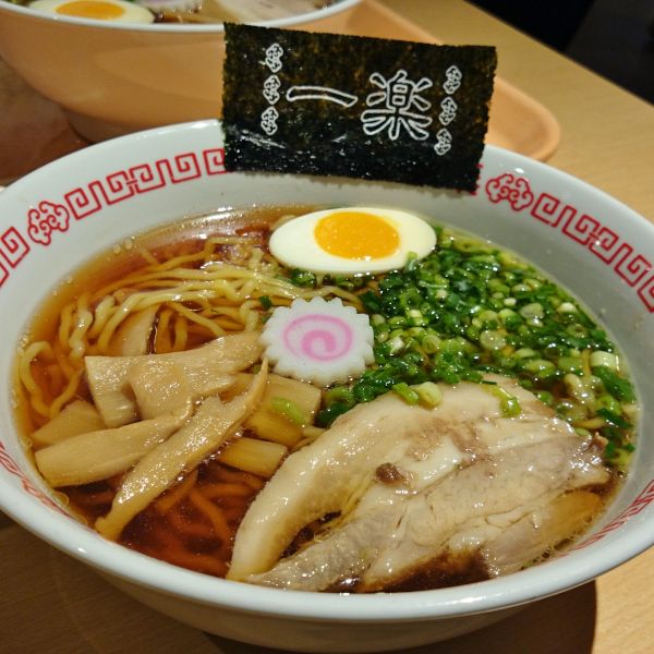 Steaming bowl of Naruto's favourite ramen served at J-World Tokyo, complete with narutomaki and a flavorful broth