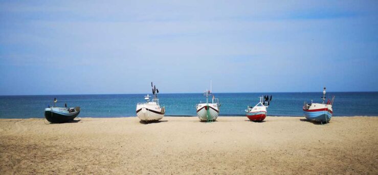 fishing idyll with traditional fishing boats pulled onto the beach in Vorupør, Denmark