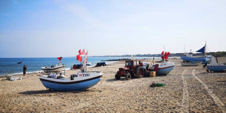 tractors still pull the fishing boats onto the beach in Vorupør, Denmark