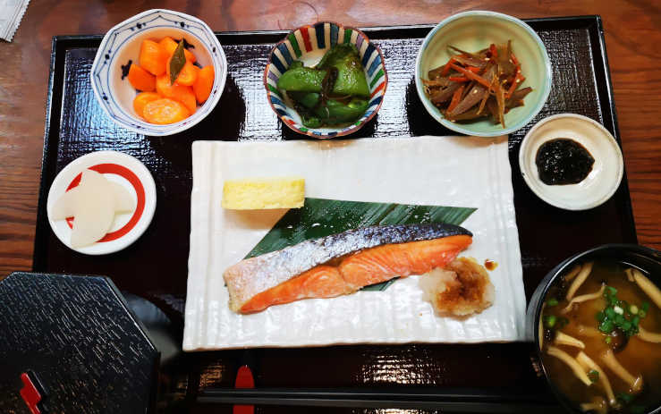 Breakfast tray at a Tokyo ryokan with fish and side dishes in a traditional setting