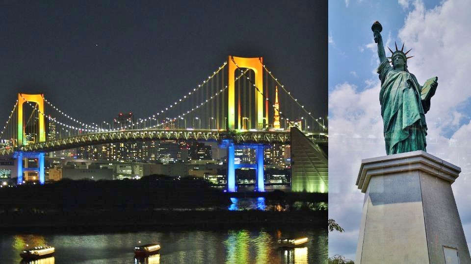 Illuminated Rainbow Bridge spanning Tokyo Bay with city lights at night in Odaiba Tokyo