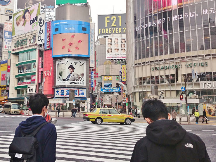Nearly empty Shibuya Crossing with crosswalks and traffic lights visible in Tokyo