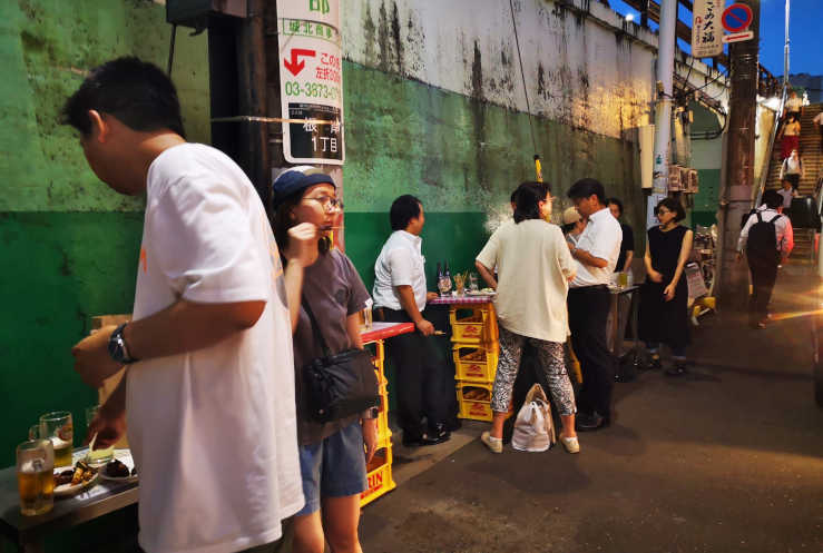 Small local bar with street food stalls and outdoor seating in Taito Tokyo near the Yamanote Line