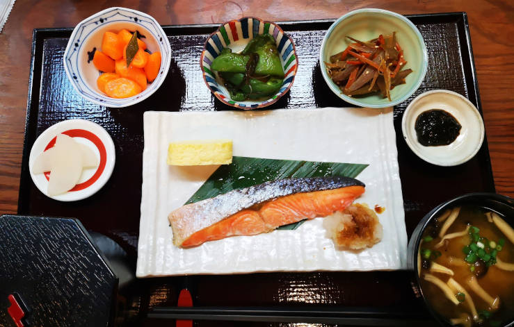 Traditional Japanese meal with various dishes, beautifully presented
