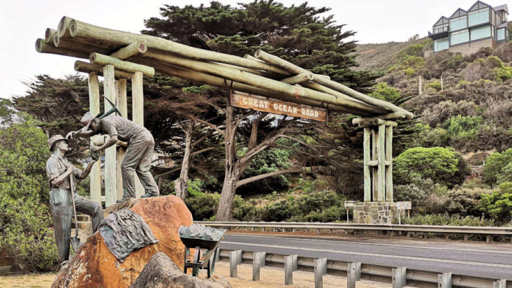 Cultural travel method - Road builders working on the Great Ocean Road in Australia, carving the coastal route into cliffs overlooking the ocean