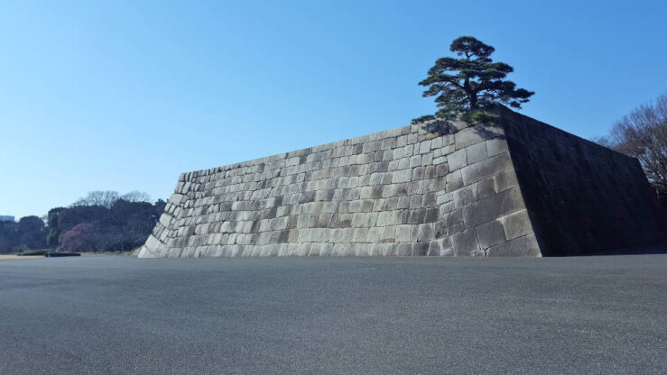 Japan Travel Guide - Stone wall section of the Tokyo Imperial Palace exterior with traditional Japanese construction and historic defensive architecture