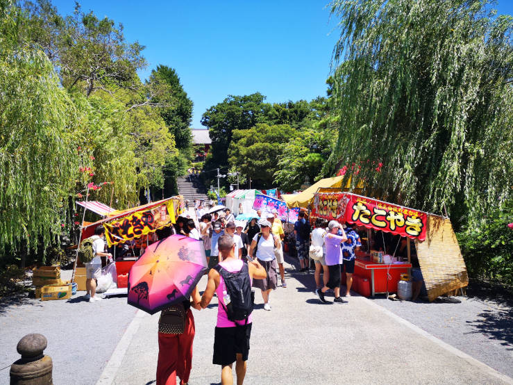 Visitors exploring festival stalls in Ueno Park, Tokyo