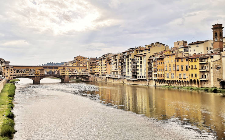 Arno River flowing through Florence with Ponte Vecchio bridge in the historic centre of Tuscany, Italy