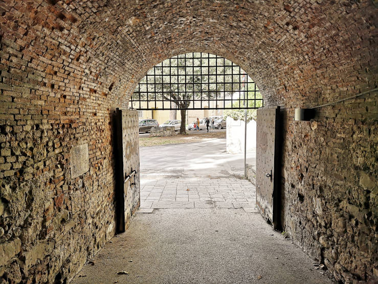 View through a gate in Lucca's Renaissance walls at the historic centre, Tuscany, Italy