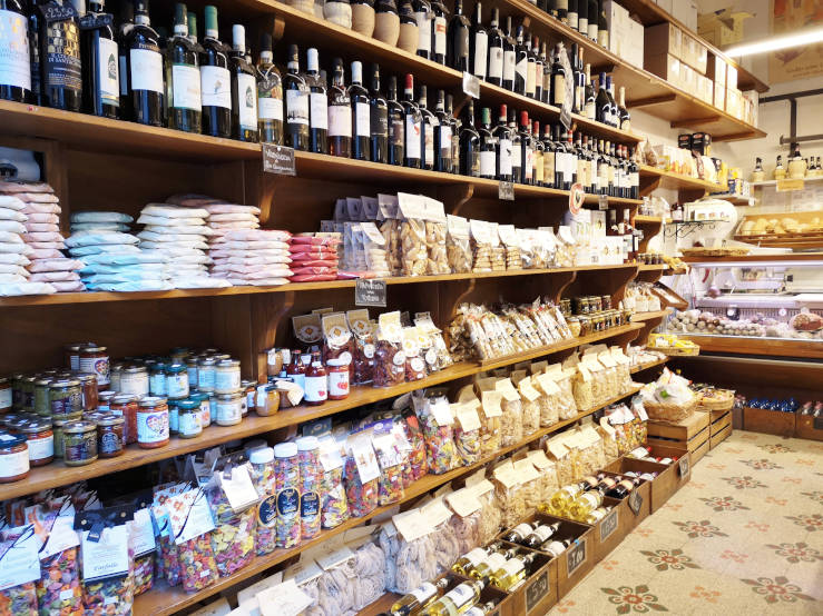 Shelves of Vernaccia wine and local products in a shop in San Gimignano